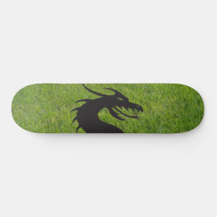 Dragon silhouette, with grass in the background, skateboard