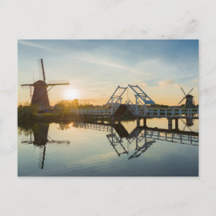 Drawbridge and windmills at sunset in Holland Postcard
