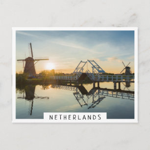 Drawbridge and windmills at sunset in Holland Postcard