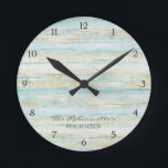 Driftwood Ocean Beach House Coastal Seashore Round Clock<br><div class="desc">COLOR PALETTE: Soft grey, blue and tan DESIGN COLLECTION: This entire collection of Beach House Home Décor Accessories can be personalised with your name, monogram or message. Use the easy to customise template fields. Hand painted in watercolor, this simple yet trendy driftwood, worn, faded, distressed antiqued wooden background has great...</div>