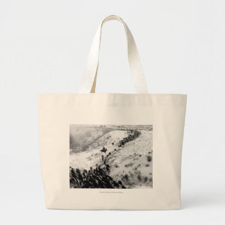 Driving cattle in the winter. large tote bag
