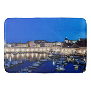 Dubrovnik harbor and walls illuminated at night bath mat