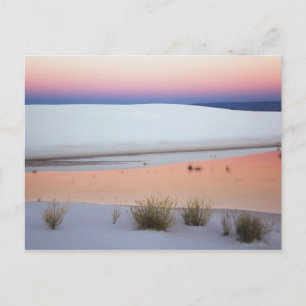 Dusk sky reflected in pool of water from postcard