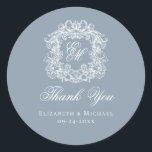 Dusty Blue Monogram Wedding Crest Thank You Classic Round Sticker<br><div class="desc">These elegant classic dusty blue wedding monogram thank you stickers are perfect for favors, place cards, and more. They feature an ornate vintage crest with intertwined fancy script calligraphy monogram, and script Thank You. Find matching products in the collection, or message me through Zazzle Chat for more products and design...</div>