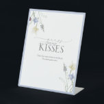 Dusty Blue Wildflower How Many Kisses Pedestal Sign<br><div class="desc">This softly framed pedestal sign adds a charming, elevated touch to your shower gamescape. With delicate watercolor florals and a dusted blue border, it sets the tone for a game that’s playful yet polished—perfect for pairing with your matching guess cards and candy jar display. Ideal for countryside venues, cottagecore-inspired gatherings,...</div>