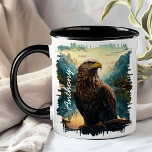 Eagle in Mountain Wilderness  Mug<br><div class="desc">Soar into your day with the Eagle in Mountain Wilderness Mug. This striking mug features a majestic eagle perched on a branch, set against a backdrop of rugged mountains and dense forests. Customised with your name, it adds a personal touch that makes it uniquely yours. Perfect for coffee, tea, or...</div>