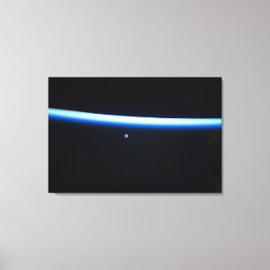 Earth's Thin Line Of Atmosphere And A Gibbous Moon Canvas Print