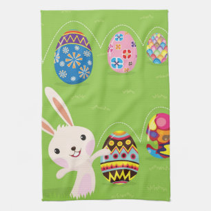 Easter bunny playful with painted eggs tea towel