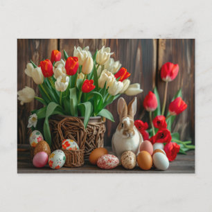 Easter bunny seated beside colorful eggs and tulip postcard