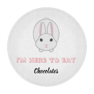 Easter bunny waiting to eat chocolates cutting board