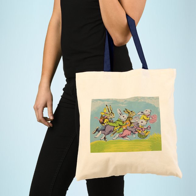 Easter Running Pastel Rabbits Tote Bag (Group Easter bunnies running in grass baskets coloured eggs blue sky clouds on tote bag for Easter.)