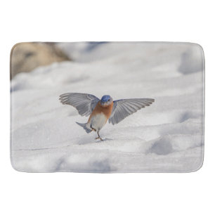 Eastern Bluebird dancing in the snow Bath Mat