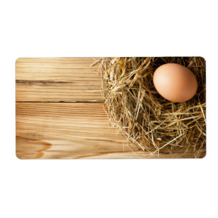 Egg In Hay Nest On Wooden Table Background