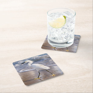 Egret on shoreline square paper coaster