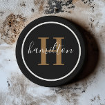 Elegant Black Brown Round Monogram Dark Coaster<br><div class="desc">An elegant sandstone coaster featuring a warm cognac tan brown serif initial and custom family name in script, framed by a circle on a rich black background. The warm cognac-toned typography against dark stone creates a distinguished, leather-inspired aesthetic. A sophisticated personalised gift for groomsmen, housewarmings, or milestone celebrations. All text...</div>