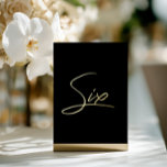 Elegant Black & Gold Foil Wedding Table Number<br><div class="desc">Add a touch of modern luxury to your wedding reception with this minimalist arched table number, featuring an elegant gold foil look script on clear acrylic. The design mimics real foil with a subtle printed shimmer, offering an upscale effect without the cost. Perfect for modern, chic, or romantic wedding themes....</div>