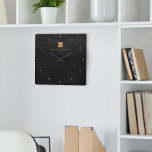 Elegant black gold monogram name personalised<br><div class="desc">Luxury monogrammed square wall clock with a black leather look background and a faux gold copper metallic brushed square with elegant script signature name and monogram initials. Easy to personalise and create your own logo with your business or personal initials and name. Could be an elegant personalised gift for a...</div>