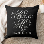 Elegant Black Mr and Mrs Script Wedding Cushion<br><div class="desc">An elegant black throw pillow featuring Mr. and Mrs. in flowing white calligraphy script with a customisable family name. The bold white-on-black contrast delivers a dramatic,  modern wedding gift or striking newlywed home accent. All text is fully editable to personalise with the couple's name.</div>