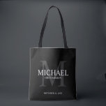 Elegant Black Personalised Groomsmen Tote Bag<br><div class="desc">Add a personal touch to your wedding with personalised groomsmen tote bag. This bag features personalised groomsman's name with title and wedding date in white and monogram in grey as background, in classic serif font style, on black background. Also perfect for best man, father of the bride, ring bearer and...</div>