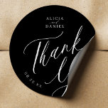 Elegant calligraphy wedding thank you favour black classic round sticker<br><div class="desc">Elegant simple minimal black and white wedding favour thank you sticker featuring a classy stylish chic trendy calligraphy script.                      Easy to personalise with your details! Suitable for formal black tie neutral weddings.                 Please note that the background and text colours can be changed to match your wedding colour scheme.</div>