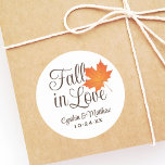 Elegant Fall in Love Autumn Wedding Monogram Classic Round Sticker<br><div class="desc">"Fall in Love" themed wedding favour stickers feature an orange maple leaf and chocolate brown customisable monogram of the bride and groom's names and wedding date.  Ivory / ecru background colour.</div>