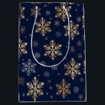 Elegant Gold and Silver Snowflakes on Navy Blue Gi Medium Gift Bag<br><div class="desc">This image features a roll of elegant gift wrapping paper decorated with large, artistic gold-coloured snowflake designs set against a deep navy blue background. The pattern includes various intricate snowflake shapes, some highlighted with a gold metallic effect and others in subtle contrasting tones. This luxurious and festive wrapping paper is...</div>