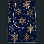 Elegant Gold and Silver Snowflakes on Navy Blue Gi Medium Gift Bag<br><div class="desc">This image features a roll of elegant gift wrapping paper decorated with large, artistic gold-coloured snowflake designs set against a deep navy blue background. The pattern includes various intricate snowflake shapes, some highlighted with a gold metallic effect and others in subtle contrasting tones. This luxurious and festive wrapping paper is...</div>