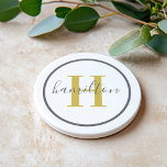 Elegant Gold Gray Round Monogram Script Coaster<br><div class="desc">An elegant sandstone coaster featuring a warm gold serif initial and custom family name in script, framed by a soft gray circle on a white background. The gentle gold and gray palette creates a luminous, feminine accent for any home. A lovely personalized gift for weddings, bridal showers, or housewarmings. All...</div>