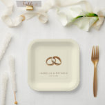 Elegant Gold Minimalist Rings Paper Plate<br><div class="desc">This elegant wedding plate features a minimalist design with two interlocking golden rings set against a soft beige background, creating a luxurious and sophisticated look. The clean layout emphasizes the unity symbolized by the intertwined rings, while the classic serif font adds a touch of formality to the overall aesthetic. Perfect...</div>