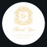 Elegant Gold Monogram Wedding Crest Thank You Classic Round Sticker<br><div class="desc">These elegant classic gold wedding monogram thank you stickers are perfect for favors, place cards, and more. They feature an ornate vintage crest with intertwined fancy script calligraphy monogram, and script Thank You. Find matching products in the collection, or message me through Zazzle Chat for more products and design tweaks....</div>