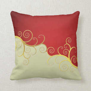 Elegant golden swirls on red and cream cushion