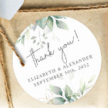 Elegant greenery eucalyptus names and wedding date classic round sticker<br><div class="desc">These romantic and elegant floral Thank you stickers make the perfect seal for your wedding favour, presenting a chic botanical design that features a classy bouquet of light and airy watercolor greenery and eucalyptus leaves complemented with glittery golden speckles (printed) and is easily customisable with your names and wedding date....</div>