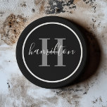 Elegant Grey Black Round Monogram Dark Coaster<br><div class="desc">An elegant sandstone coaster featuring a grey serif initial and custom family name in script, framed by a circle on a dramatic black background. The dark palette with refined grey typography creates a bold, masculine accent for a home bar or study. A striking personalised gift for groomsmen, Father's Day, or...</div>