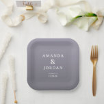 Elegant Lavender Minimalist Paper Plate<br><div class="desc">This elegant wedding plate features a minimalist design with a gradient lavender and lilac color palette, creating a soft and sophisticated atmosphere. The centered composition highlights the names "Amanda & Jordan" in clean, sans-serif typography, accompanied by smaller serif fonts for location and date details, ensuring clarity and focus. The absence...</div>
