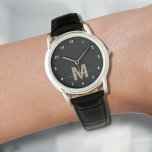 Elegant Modern Black Gold Monogram Watch<br><div class="desc">Personalised Monogram Black and White Watch with Simple White Numbers. This sleek, minimalist watch combines classic style with a personal touch, featuring a bold gold-coloured initial (note: the gold is a flat colour without any shimmer) on a black face, accented by simple white numbers for easy reading. The design also...</div>
