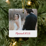 Elegant Photo Modern First Christmas Married Ceramic Ornament<br><div class="desc">Modern and simple photo Christmas ornament featuring two of your favourite photos. The front has one picture with "Married" along with the year in a thick red script typography over a white banner. The backside has a full bleed picture. This personalised holiday ornament is the perfect way to commemorate your...</div>