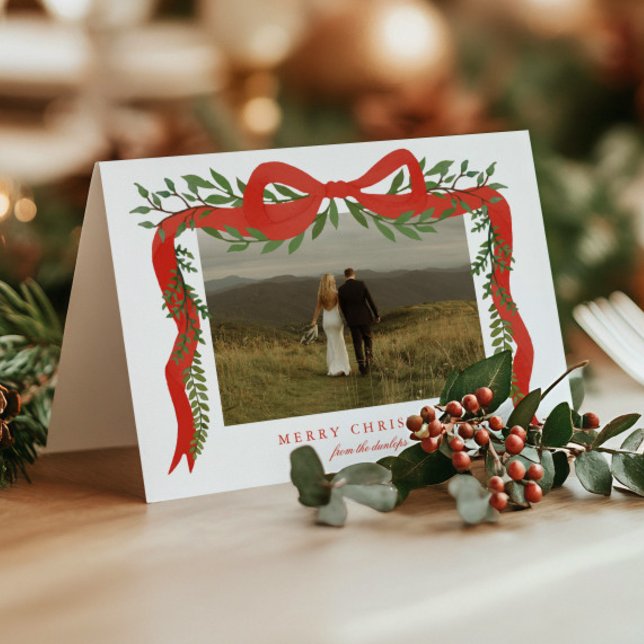 Elegant Red Bow with Greenery Photo Christmas Holiday Card (Elegant red ribbon with bow and greenery folded photo Christmas holiday cards. )