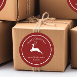 Elegant Red Merry Christmas Reindeer Custom Gift Classic Round Sticker<br><div class="desc">An elegant white reindeer leaps underneath Merry Christmas. Personalise these red holiday gift labels your family name underneath for beautiful custom presents.</div>