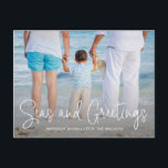 Elegant Seas and Greetings Beach Photo Christmas Holiday Postcard<br><div class="desc">Send out holiday cheer with this nautical themed Christmas postcard featuring a simple design with the words "Seas and Greetings" in an elegant thin white script,  along with your message over your favourite horizontal beach vacation photo.  The backside has your personal message and your return address for easy mailing.</div>