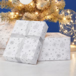 Elegant Silver Snowflakes White Christmas Wrapping Paper<br><div class="desc">Introducing our Modern Christmas Wrapping Paper, a sophisticated embodiment of winter's beauty and contemporary elegance. This wrapping paper features a pristine white background adorned with a mesmerising pattern of small silver snowflakes. Delicately cascading across the surface, the shimmering silver snowflakes evoke the magic of a winter wonderland, capturing the essence...</div>