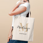 Elegant Tan Black Custom Wedding Bridesmaid Name Tote Bag<br><div class="desc">Elegant custom wedding tote bag features a personalised monogram typography design with modern calligraphy script name and serif monogram initial in neutral light tan brown and black colours. Includes custom text for a bridal party title like "BRIDESMAID" or other preferred wording.</div>