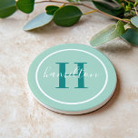 Elegant Teal Green Round Monogram Script Coaster<br><div class="desc">An elegant sandstone coaster featuring an emerald teal green serif initial and custom family name in script, framed by a white circle on a fresh minty seafoam background. The cool green tones bring a soothing, nature-inspired freshness to any space. A lovely personalised gift for housewarmings, garden lovers, or coastal homes....</div>