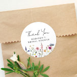 Elegant Wildflower Meadow Bridal Shower Thank You Classic Round Sticker<br><div class="desc">Elegant floral bridal shower thank you stickers featuring a bottom border of watercolor wildflowers and foliage in shades of pink, yellow, purple, blue, and green on a white background. Personalise the wildflower bridal shower thank you stickers with the bride-to-be's name. The personalised wildflower stickers are perfect for spring and summer...</div>