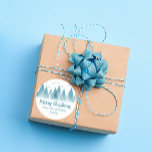 Elegant Winter Trees Custom Blue Merry Christmas Classic Round Sticker<br><div class="desc">An elegant row of winter fir trees and snowflakes above your personalised Merry Christmas script and your family last name in pretty blue below the snow filled forest. A modern holiday design with your custom message on lovely gift stickers.</div>
