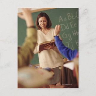 Elementary school students raising their hands postcard