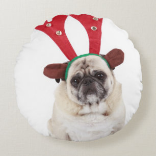 Embarrassed looking Pug wearing Reindeer Antlers Round Cushion