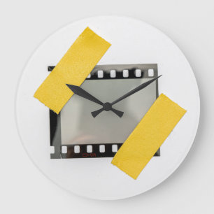 Empty 35mm film frame, yellow strips. large clock