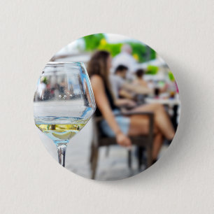 Empty glass from wine and blurred silhouettes 6 cm round badge
