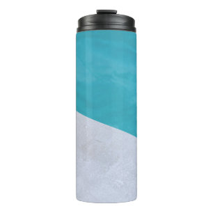 Empty grey floor beside pool thermal tumbler