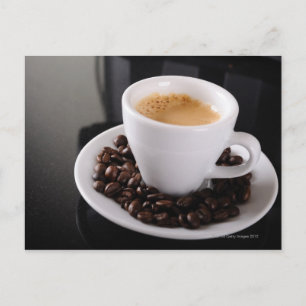 Espresso cup on black granite counter postcard
